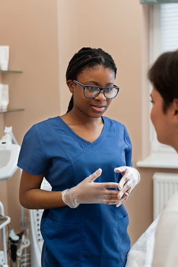 A nurse having a conversation with the doctor.